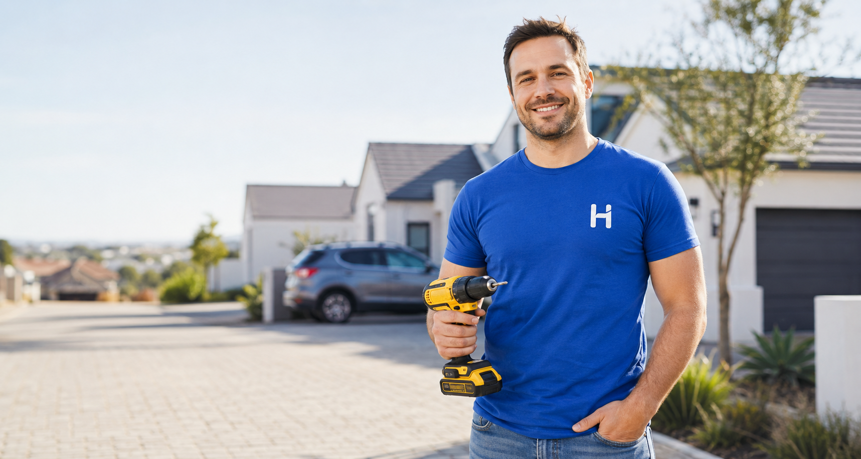 A smiling HireHopping member holding a cordless drill